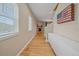 Inviting hallway featuring hardwood floors, fireplace in view, and natural light from window at 23831 Eagle Bend Ln, Parker, CO 80138