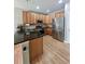 Modern kitchen with dark countertops, stainless steel appliances, and wood cabinets at 23831 Eagle Bend Ln, Parker, CO 80138