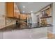 This kitchen features granite countertops, tiled backsplash, stainless appliances, and custom wood cabinetry at 23831 Eagle Bend Ln, Parker, CO 80138