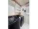 Laundry room featuring a modern washer and dryer, and custom storage at 23831 Eagle Bend Ln, Parker, CO 80138