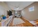 Sitting area has hardwood floors, neutral walls, ceiling fan, and modern shelving unit with decor at 23831 Eagle Bend Ln, Parker, CO 80138