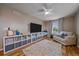 Sitting area features hardwood floors, contemporary shelving unit, ceiling fan, and neutral colored walls at 23831 Eagle Bend Ln, Parker, CO 80138