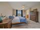 A main bedroom with a ceiling fan, plush carpet, and views of the outdoor area at 23831 Eagle Bend Ln, Parker, CO 80138