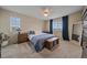 This main bedroom has lots of natural light, ceiling fan, plush carpet, and a cool blue accent wall at 23831 Eagle Bend Ln, Parker, CO 80138