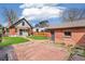 View of a beautiful backyard with brick patio, grassy area, and detached garage at 2826 Quitman St, Denver, CO 80212