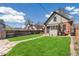 Charming backyard featuring a well-manicured lawn, stone path, and a privacy fence at 2826 Quitman St, Denver, CO 80212