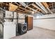 Unfinished basement with exposed pipes and ductwork, washer and dryer, and storage area at 2826 Quitman St, Denver, CO 80212