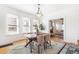 Open dining room with decorative light fixture, hardwood floors, and sun-filled windows at 2826 Quitman St, Denver, CO 80212