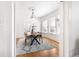 Bright dining room featuring a modern light fixture, hardwood floors, and three large windows at 2826 Quitman St, Denver, CO 80212