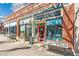 Exterior shot of 32nd Avenue Books Toys Gifts featuring a red door and merchandise display at 2826 Quitman St, Denver, CO 80212