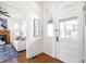 Bright foyer with hardwood floors and a view into the adjacent living area at 2826 Quitman St, Denver, CO 80212