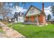 Charming brick home with a well-manicured lawn and inviting front porch at 2826 Quitman St, Denver, CO 80212