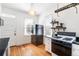 Efficient kitchen featuring a gas range, floating shelves, and hardwood flooring at 2826 Quitman St, Denver, CO 80212