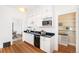 Galley kitchen boasts granite countertops and new cabinetry at 2826 Quitman St, Denver, CO 80212