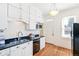 Kitchen with granite countertops, stainless appliances and white cabinetry at 2826 Quitman St, Denver, CO 80212