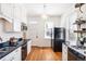 Efficient kitchen featuring a gas range, new cabinets, and hardwood flooring at 2826 Quitman St, Denver, CO 80212
