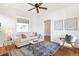 Bright living room with hardwood floors, a comfortable couch, and large windows at 2826 Quitman St, Denver, CO 80212