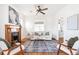 Inviting living room with a charming fireplace, ceiling fan, and hardwood floors at 2826 Quitman St, Denver, CO 80212