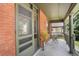 Inviting front porch with seating area and a decorative brick exterior at 2826 Quitman St, Denver, CO 80212
