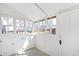 Sun room featuring ample natural light, charming cabinetry, and wainscotting at 2826 Quitman St, Denver, CO 80212