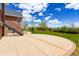 Landscaped backyard with patio, stairway, manicured lawn, gazebo, and mature trees at 2366 Shoreside Dr, Berthoud, CO 80513