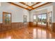 Bedroom with wooden-framed windows, recessed paneling, ceiling detail, and hardwood floors at 2366 Shoreside Dr, Berthoud, CO 80513