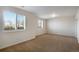 Bright bedroom with carpet, neutral paint, and large windows with views of the landscape at 2366 Shoreside Dr, Berthoud, CO 80513