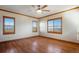 Bedroom with wooden floors, a ceiling fan, and plenty of natural light at 2366 Shoreside Dr, Berthoud, CO 80513