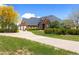 This brick home features manicured front lawn and landscaping with a long driveway and three-car garage at 2366 Shoreside Dr, Berthoud, CO 80513