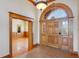 Inviting foyer with hardwood floors, decorative wood trim and access to the living room at 2366 Shoreside Dr, Berthoud, CO 80513