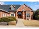 Charming brick home featuring a classic arched entryway, bay window and manicured shrubs at 2366 Shoreside Dr, Berthoud, CO 80513