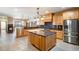 Well-lit kitchen with stone countertops, an island with seating, and stainless steel appliances at 2366 Shoreside Dr, Berthoud, CO 80513