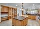 Kitchen showcases an island, lots of cabinet storage, and granite countertops at 2366 Shoreside Dr, Berthoud, CO 80513