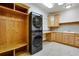 Convenient laundry room featuring modern stacked washer and dryer units at 2366 Shoreside Dr, Berthoud, CO 80513