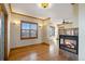 Living area with fireplace, beautiful hardwood flooring and window with shutters at 2366 Shoreside Dr, Berthoud, CO 80513
