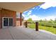 Covered brick patio with iron railing offering outdoor living and picturesque views at 2366 Shoreside Dr, Berthoud, CO 80513