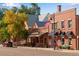 Charming downtown street view with brick buildings, businesses, and street parking at 2366 Shoreside Dr, Berthoud, CO 80513