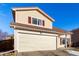 Two-story house with beige siding, brown roof, and attached garage at 4152 Netherland St, Denver, CO 80249