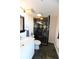 This bathroom features a white vanity and a walk-in shower with black and gold accents at 1020 15Th St # 29L, Denver, CO 80202