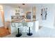 Bright kitchen with white cabinetry, a marble countertop breakfast bar and stainless steel appliances at 1020 15Th St # 29L, Denver, CO 80202