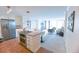 Open-concept kitchen with island, stainless steel appliances, and seamless access to the living room at 1020 15Th St # 29L, Denver, CO 80202