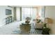 Bright living room featuring a modern sofa, plush carpet, and access to a private balcony at 1020 15Th St # 29L, Denver, CO 80202