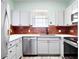 Well-equipped kitchen featuring stainless steel appliances and stylish brick backsplash at 7423 S Quail Cir # 1533, Littleton, CO 80127