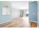 Bright living room with an open archway, balcony access, and laminate floors at 7423 S Quail Cir # 1533, Littleton, CO 80127