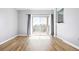 Bright living room featuring wood floors and sliding doors opening to a private balcony at 7423 S Quail Cir # 1533, Littleton, CO 80127