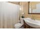 Classic bathroom design with a pristine white shower curtain, a rustic vanity, and a cozy ambiance at 9410 Cedar Ct, Thornton, CO 80229