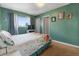 Bright bedroom with a floral bedspread, natural light, and carpeted floors at 9410 Cedar Ct, Thornton, CO 80229
