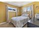 Inviting bedroom with two windows and a patterned comforter, providing a relaxing space at 9410 Cedar Ct, Thornton, CO 80229