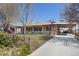 A single-story home with charming curb appeal, featuring a long driveway and well-maintained yard at 9410 Cedar Ct, Thornton, CO 80229