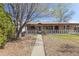 Charming single-story home with a welcoming front porch and beautifully maintained landscaping at 9410 Cedar Ct, Thornton, CO 80229